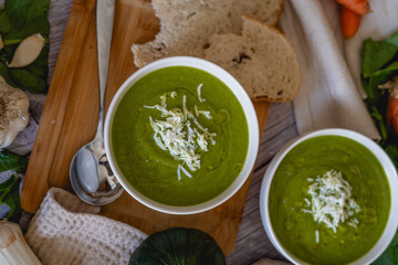 green vegetable cream in a bowl with surrounding ingredients.