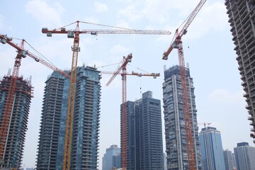 Fototapeta premium Large construction site city high-rise buildings cranes construction