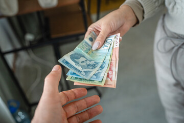 Hand exchanging various denominations money serbian dinar banknotes