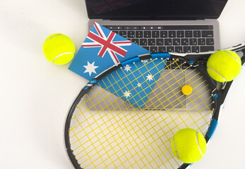 Australia flag concept with tennis racket and laptop on top view. 