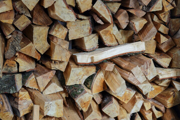Stacked split logs, pieces of wood, firewood, texture, background, abstract