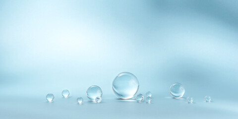 Blue background with transparent glass balls. Minimal concept and hard sunlight.
