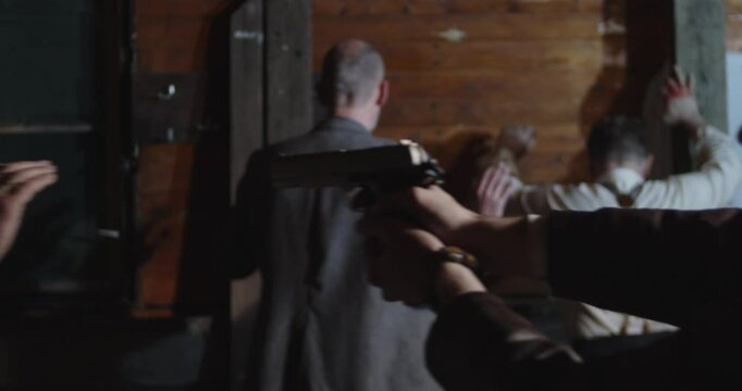 Prohibition era concept - A detective forces criminals to surrender and stand against a wall