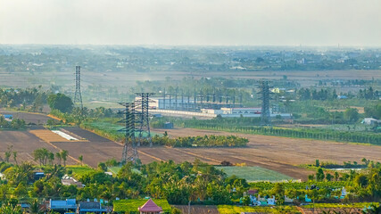 A shot of high voltage electric transmission tower, also known as electricity pylon, from windfarm...