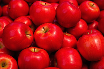 Dense pile of shiny red apples ripeness smooth sheen