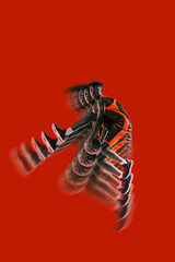 Basketball player mid-air holding ball, bold red background. Stroboscopic effect enhances dynamic...