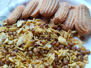 Indian snack: Mixture, Biscuit and Spicy Namkeen in plate for guests
