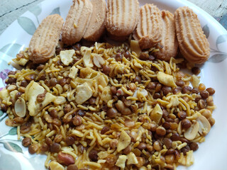 Indian snack: Mixture, Biscuit and Spicy Namkeen in plate for guests