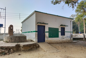 old building of primary school in Indian village, big empty play ground. Old building of primary school in Indian village. A government school building in a village
