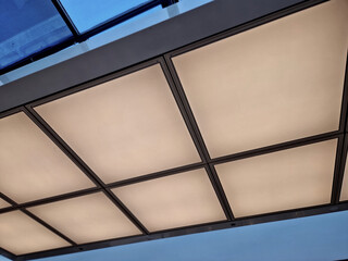 large-area lights in square shapes are matte diffused overhead lighting. skylight above the gallery