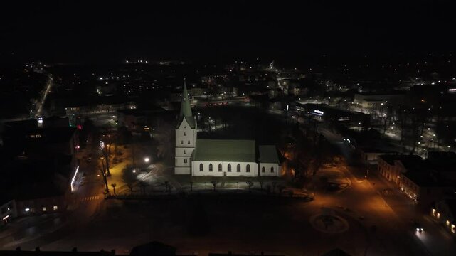 Aerial View of the Dobele City Night Landscape With a Lutheran Church. The Famous Historical Religious Building in the Town Center of Dobele, Latvia. Dobele City Panorama Nightscape