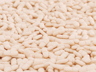 Abundant collection of beige pills on a smooth surface for medical and pharmaceutical use. 3d render