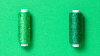 Green thread spools background with copy space for text close-up flat lay top view