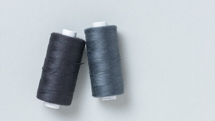 Black grey gray thread spools background with copy space for text close-up flat lay top view
