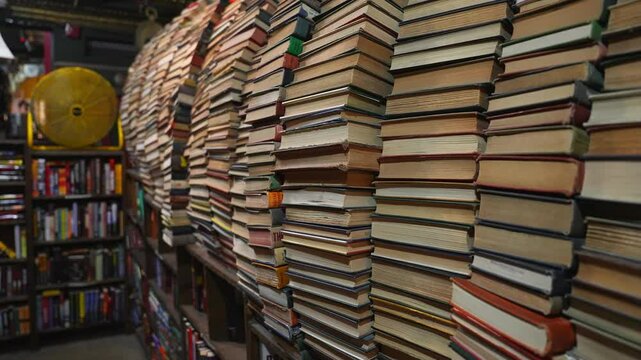 Explore the labyrinthine interior of The Last Bookstore in Los Angeles, featuring towering stacks, book arches, and vibrant colors in an artistic design.