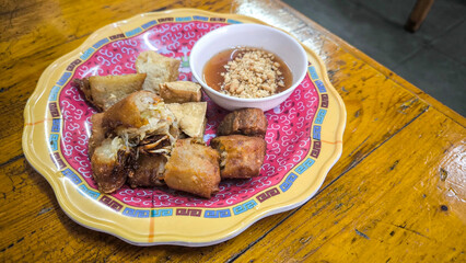 Crispy Air Fryer Tofu,Healthy cooked soybean block tofu used airfryer in black plate with chilli sweet sauce.