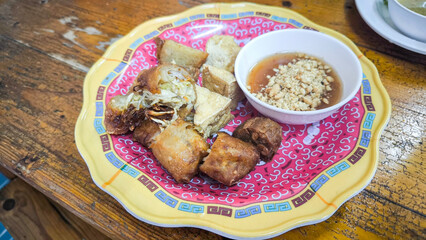 Crispy Air Fryer Tofu,Healthy cooked soybean block tofu used airfryer in black plate with chilli sweet sauce.