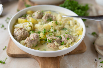 Delicious homemade cooked potato cauliflower soup with meatballs on a plate