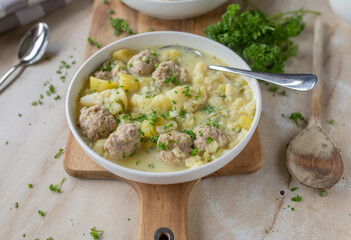 Delicious homemade cooked potato cauliflower soup with meatballs on a plate