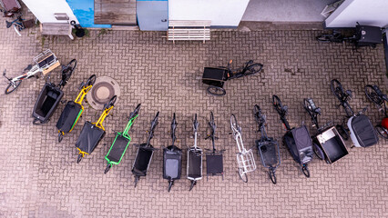 many cargo bikes in a row photographed from above