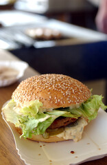 delicious burger on a paper plate