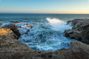 Waves crashing against rocky coastline in Malibu