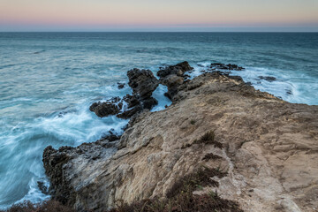 Waves crashing against rocky shore in Malibu