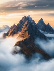 Majestic mountain landscape emerges from the fog at dawn with dramatic peaks and serene lighting