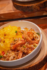 High angle, Creamy omelet with deep-fried seafood, chili and salt served with rice on dish, place on wooden board