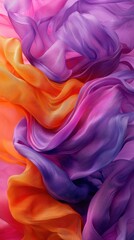 Fototapeta premium Colorful flowing fabric creates a vibrant abstract pattern with shades of orange, purple, and pink
