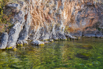 Breathtaking view of the rugged coastline of Lake Ohrid, showcasing the dramatic cliffs and crystal-clear waters.