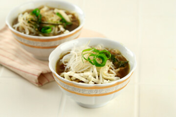 Soto CAam Mangkok Cilik. Soto is Traditional Indonesian Spice Soup with Chicken, Noodlea, and Sliced Cabbage. Served on Small Bowl