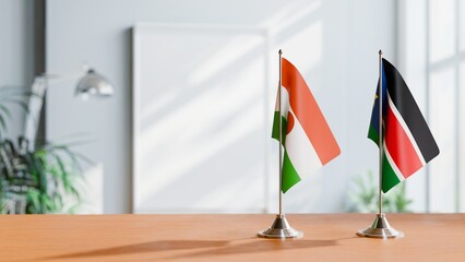 FLAGS OF NIGER AND SOUTH SUDAN ON TABLE