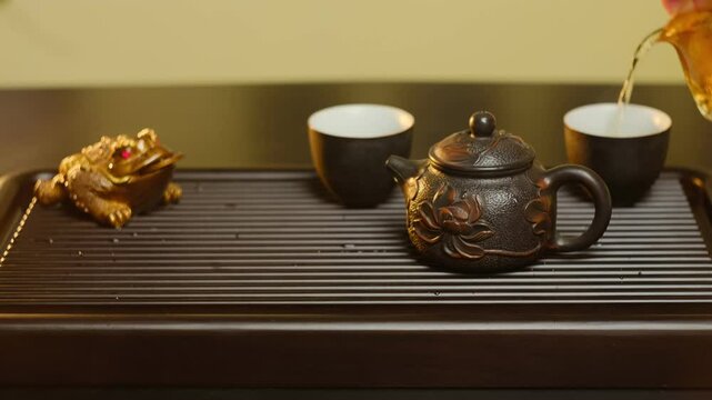 Traditional Chinese tea ceremony featuring white or green tea served in gold cups on a wooden tea tray chaban 