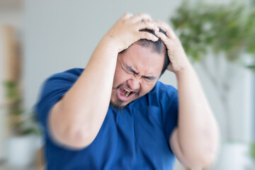 Stressful middle aged old asian man suffering from headache, health and sickness concept for...