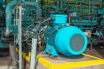 Detail of new blue electric powerful motor with pump on instalation site. Industrial background. Petrochemical pump station in petrochemical technology. Industrial area