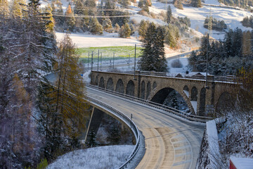 Scenic view of Solis railway viaduct and car bridge over Albula River in the Swiss Alps on a sunny...