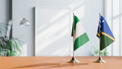 FLAGS OF NIGERIA AND SOLOMON ISLANDS ON TABLE