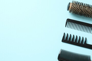 Professional combs and hairdresser tools on color background, top view