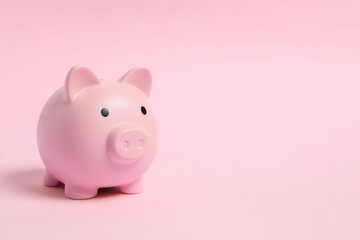 Piggy coin bank on colored background for money savings, financial security or personal funds concept.