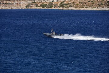 A Greek Coast Guard inflatable boat at full speed near the Attica coast