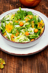 Salad with physalis and field grass