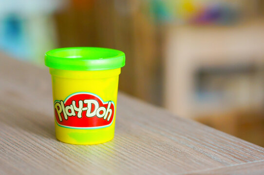 Green Play Doh clay in a container