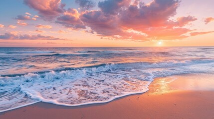 Obraz premium A serene beach at sunset, with the sky painted in shades of pink, orange, and purple, and gentle waves lapping the shore