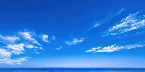 Obraz premium Expansive Blue Sky Over Calm Ocean Waves on a Clear Day