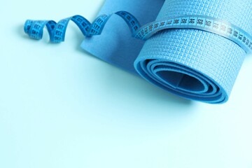 Blue mat folded into a roll on color background 