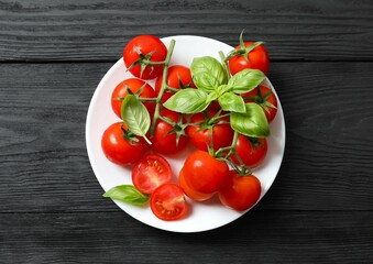 Flat lay composition with fresh cherry tomatoes on wooden background. Ripe vegetables