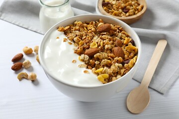 Delicious granola with yogurt on a light background