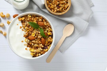 Delicious granola with berries and yogurt on a light background
