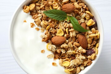 Delicious granola with berries and yogurt on a light background